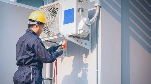 man installing heat pump